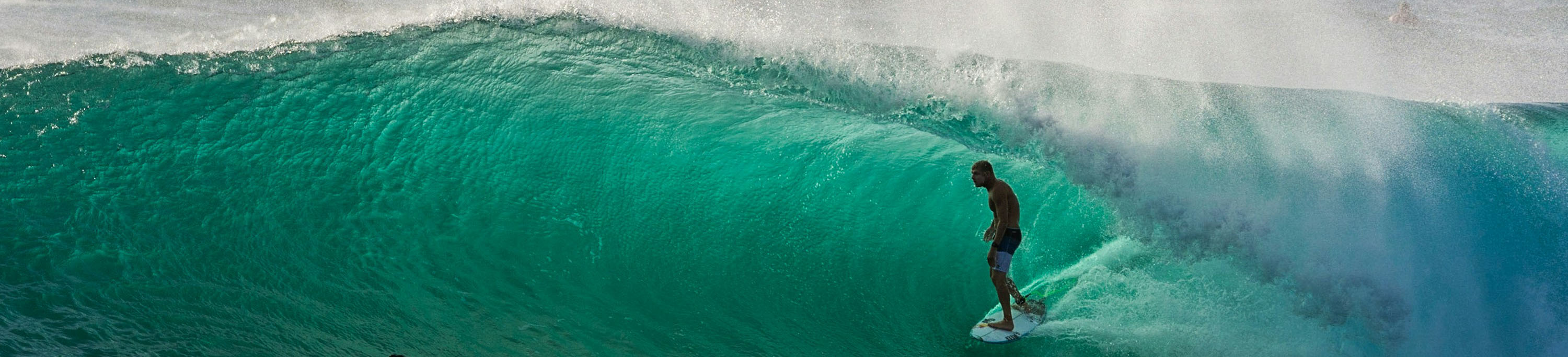 man surfing on blue water