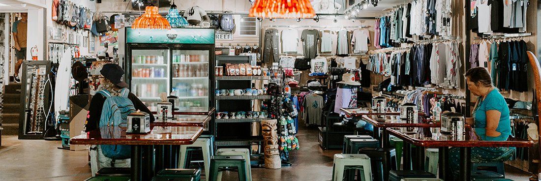 interior of a surf shop with people shopping inside